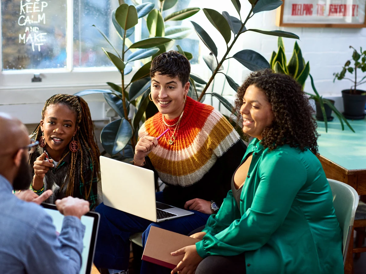 Colleagues discussing ideas around a table
